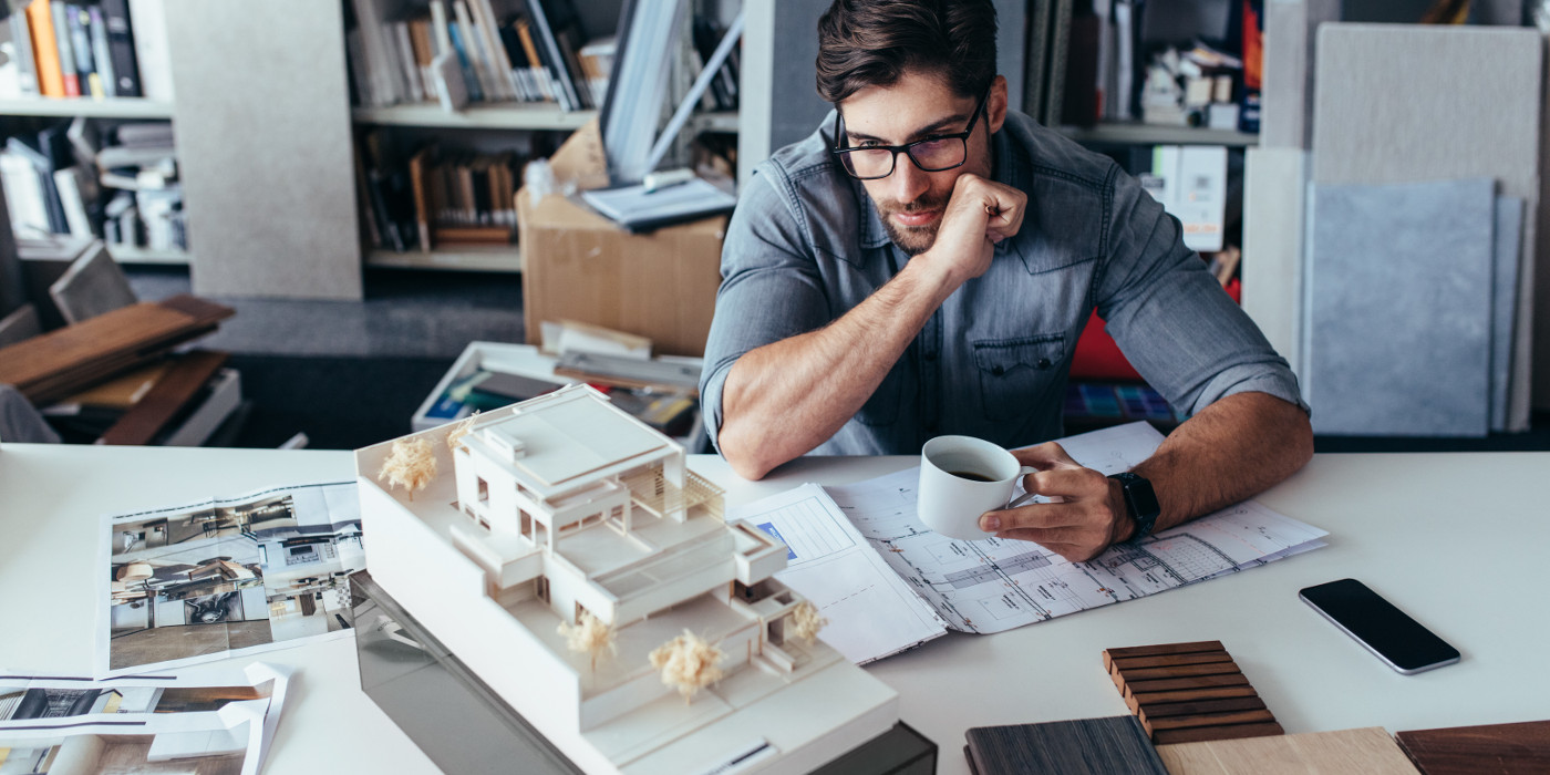 A young architect, quietly reflecting on his nearly completed model-house project.